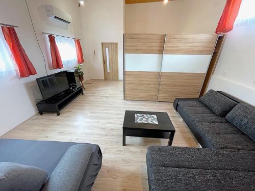 a living room with a couch and a table at Ubytování s parkováním v soukromí in Znojmo