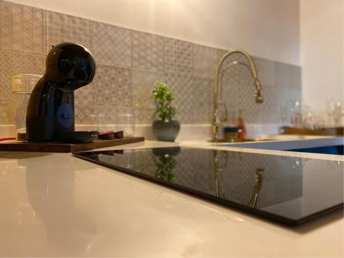 a kitchen counter top with a sink and a kitchenilit at Vista Lago Suites PY in Itauguá