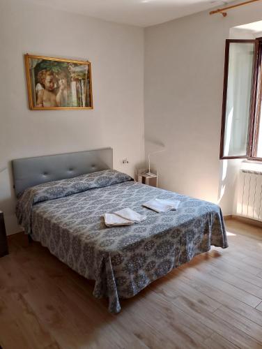 a bedroom with a bed with two towels on it at Casa Vacanze Le Cannelle in Montefiascone