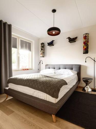 a bedroom with a large bed in a room at W Apartments Torupilli, terrace, green yard, parking in Tallinn