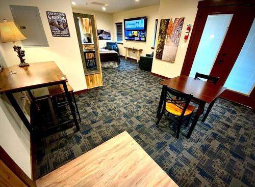 a room with a desk and a table and a living room at Bear Mountain - Suite 4 in Grants Pass