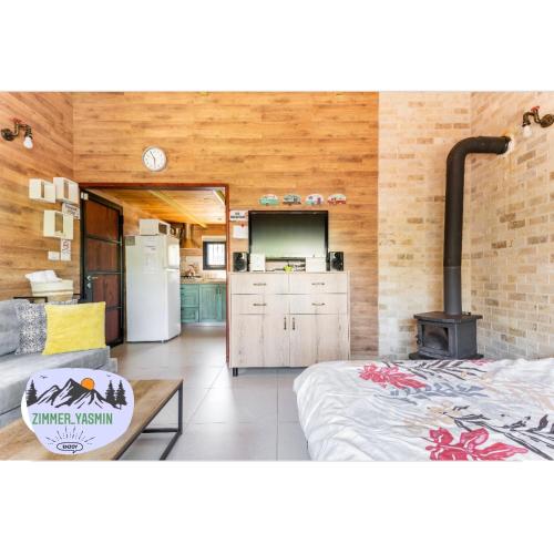 a kitchen and a living room with a stove at בקתה ואירוח היסמין מול הנוף in Majdal Shams