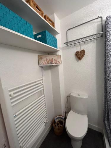 une salle de bain avec des toilettes blanches dans une chambre dans l'établissement Appartement cosy avec balcon, à Puyvalador