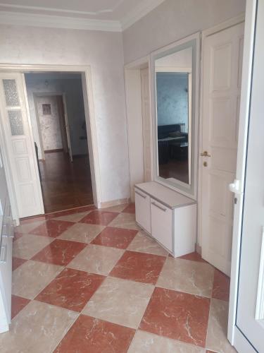 an empty room with a tiled floor and a mirror at VILA LUKA in Podgorica