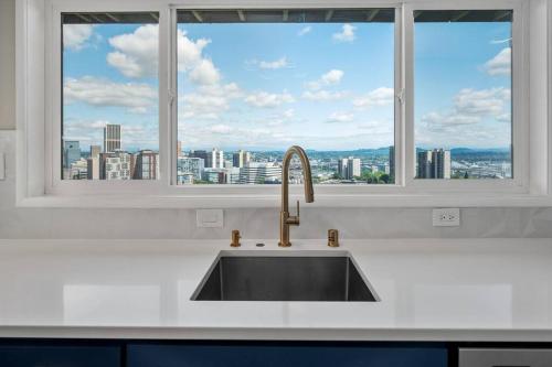 a kitchen sink with a view of a city at Breathtaking Views w/ Modern Lux - 2330 in Portland