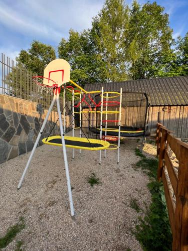 a playground with a basketball hoop in a yard at Apartament i Pokoje u Łowisza in Ciche
