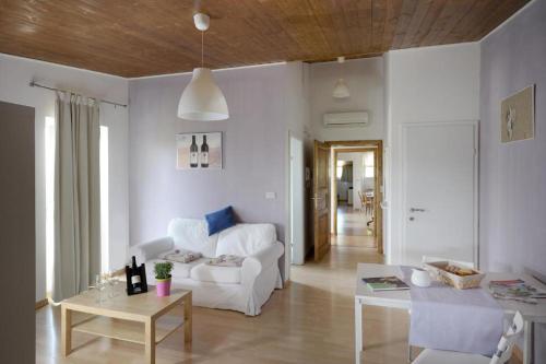 a living room with a white couch and a table at Tenuta PARAVANO in Povoletto