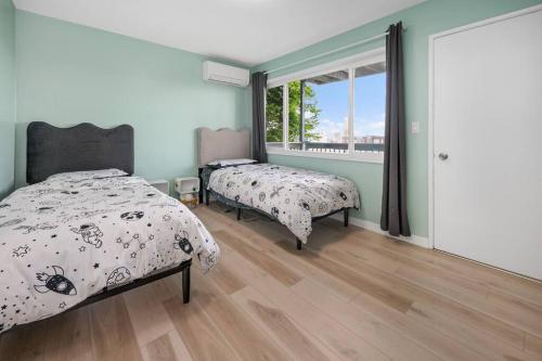 a bedroom with two beds and a window at Breathtaking Views w/ Modern Lux - 2320 in Portland