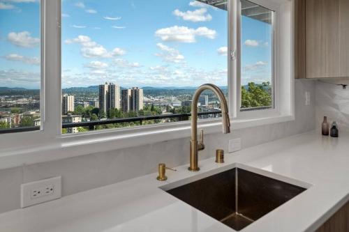 a kitchen with a sink and a window at Breathtaking Views w/ Modern Lux - 2320 in Portland