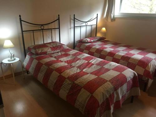 a bedroom with two beds and a window at Tenuta PARAVANO in Povoletto
