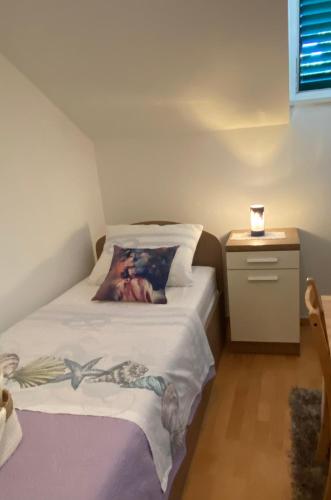 a bedroom with a bed with a picture on it at Apartment Dome in Split