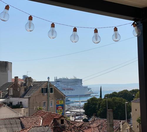 a view of a cruise ship in the ocean with lights at Apartment Dome in Split