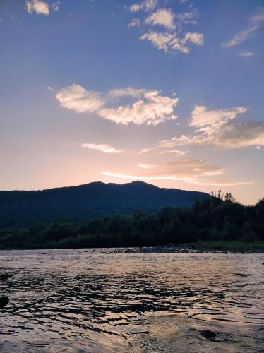 a view of a lake at sunset at Nad Cheremoshem in Tyudiv