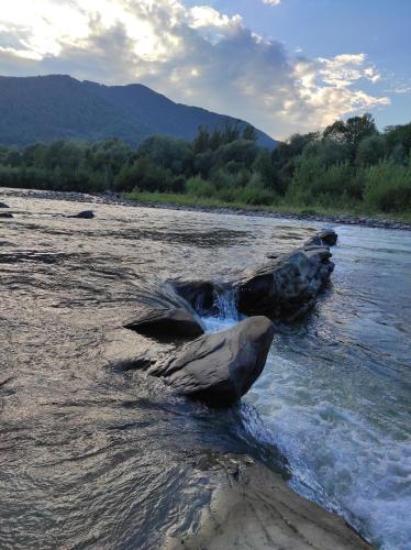 a rock in the middle of a river at Nad Cheremoshem in Tyudiv