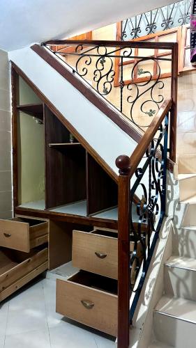 a wooden staircase with drawers and a railing at Location appartement meublée Taroudant in Taroudant
