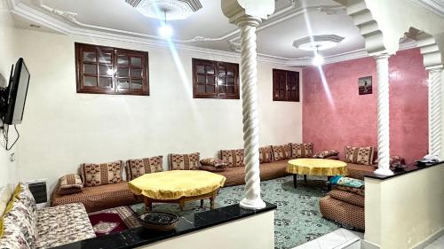 a living room with couches and tables in a room at Location appartement meublée Taroudant in Taroudant