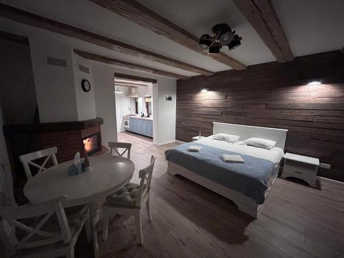 a bedroom with a bed and a table in it at Studio Alexandra in Săcele