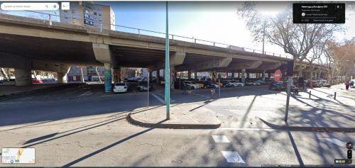 a bridge over a street with cars parked under it at metro La Salut in Badalona