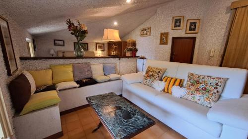 a living room with a white couch and a table at Villa Tessa in Ronciglione