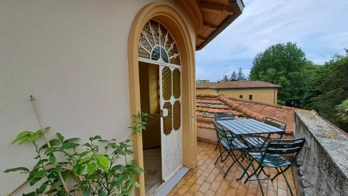 a patio with a table and chairs and a door at Villa Tessa in Ronciglione