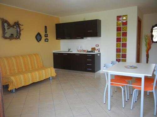 a kitchen with a table and a chair and a dining room at Il Sogno di Alghero - Adults Only in Alghero
