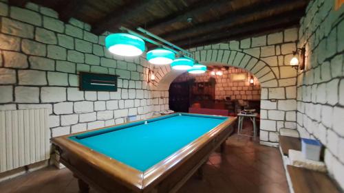a pool table in a room with a brick wall at Villa Tessa in Ronciglione