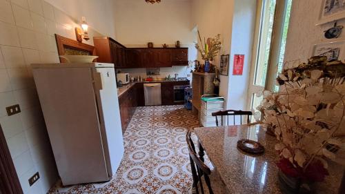 a kitchen with a refrigerator and a table in it at Villa Tessa in Ronciglione