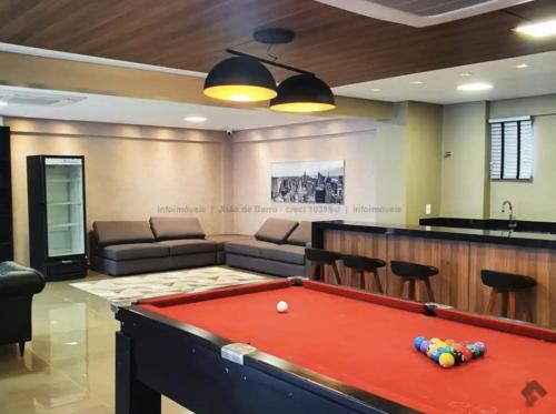 a living room with a pool table and a couch at Uma Linda Vista com Quarto Privativo no Ed. Vertigo in Campo Grande
