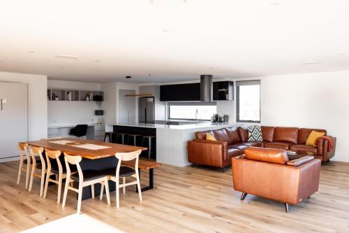 a kitchen and living room with a table and a couch at Little Island Apartments in Hobart