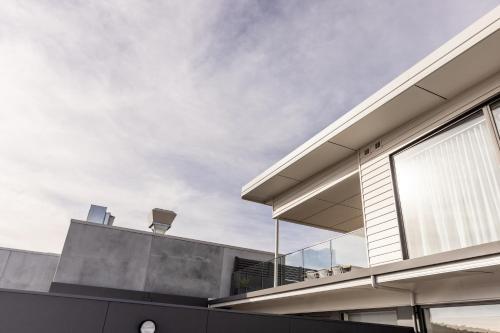a modern house with a glass facade at Little Island Apartments in Hobart