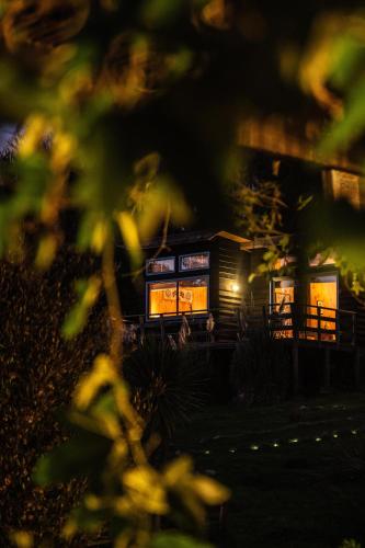 a small house with lights in front of it at Cabañas Bosques de Puertecillo in Puertecillo