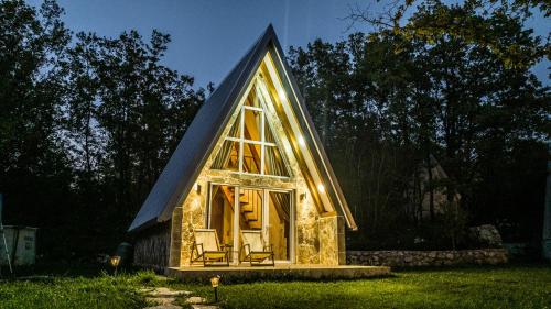a tiny house with a gambrel roof and a large window at Vukova dolina apartments in Cetinje