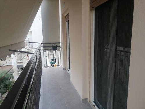 an empty hallway of a building with a balcony at Central Home in Kalamata