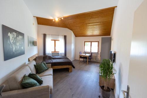 a living room with a couch and a table at Ferienwohnung Schott in Kippenheim