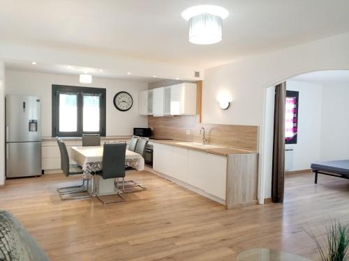 une cuisine et un salon avec une table et des chaises dans l'établissement Maison individuelle plain pied avec Spa en option PENSEZ A VALIDER VOTRE RESERVATION DANS LES 24H APRES VOTRE DEMANDE DE RESERVATION, à Perpignan
