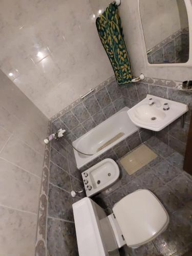 a bathroom with a toilet and a sink at Casa Lola María in Mendoza