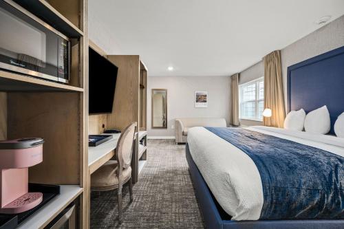 a hotel room with a bed and a desk at Alexandra Inn in Traverse City