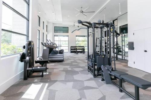 a gym with treadmills and machines in a room at West Midtown Jewel in Atlanta