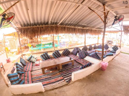 a group of reclining chairs in a pavilion at a beach at فللبررر in Nuweiba