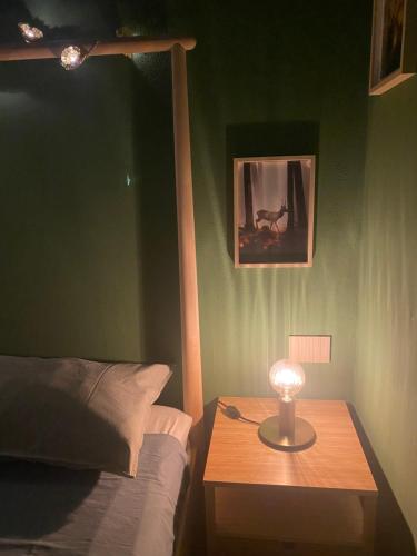 a bedroom with a bed and a table with a lamp at Sala dell Estate Guest House in Secchia