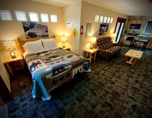a bedroom with a bed and a couch and a chair at Bear Mountain Suite 10 in Grants Pass
