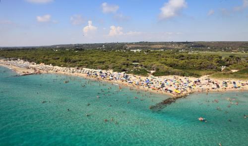 an aerial view of a beach with people in the water at B&B Vacanze Salento in Torre San Giovanni Ugento