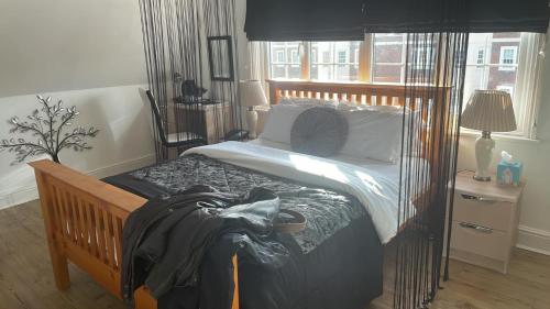 a bedroom with a bed with a wooden frame at G Boutique Hotel in Portsmouth
