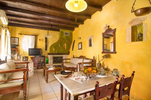 a living room with a table and a couch at Samonas Traditional Villas in Samonás