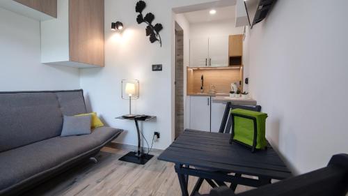 a living room with a couch and a table and a kitchen at Barbara 11 in Ustroń
