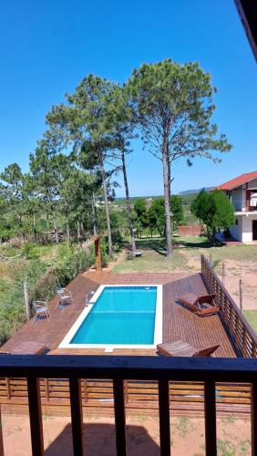 a swimming pool on a deck next to a house at Chalés Ilha da Mata Pousada in Florianópolis