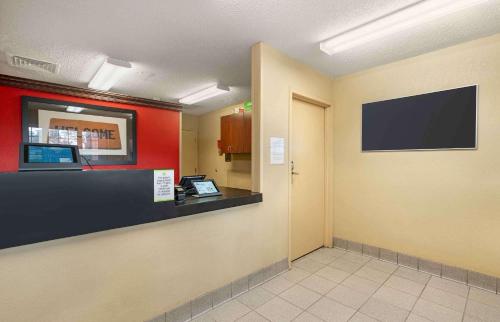 a lobby with a waiting room with a flat screen tv at Extended Stay America Select Suites - Newport News - Oyster Point in Newport News