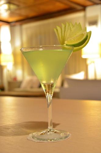 a martini glass with a lime on a table at Ino Hotel & Suites in Samos