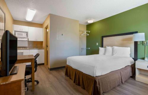 a hotel room with a bed and a desk with a computer at Extended Stay America Suites - Houston - The Woodlands in The Woodlands