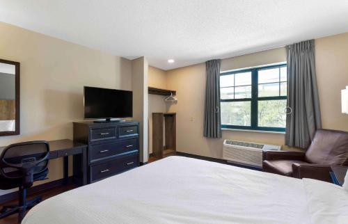 a bedroom with a bed and a desk and a television at Extended Stay America Premier Suites - Nashville - Vanderbilt in Nashville